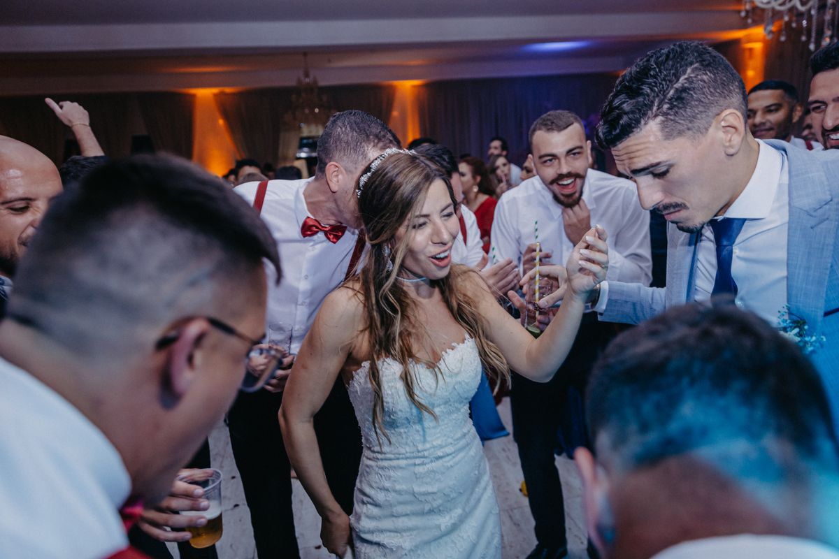 A couple's first dance surrounded by guests