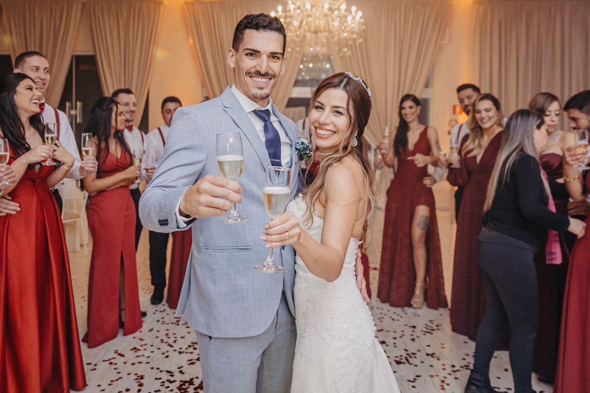 Wedding guests raising glasses to the couple